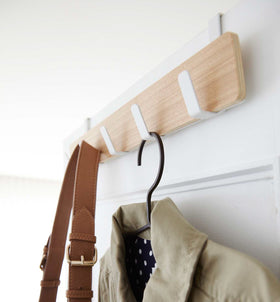 White Over-the-Door Hanger holding bag and jacket by Yamazaki Home. view 3