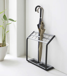 Black Expandable Shoe Rack holding in entryway holding shoes by Yamazaki home. view 2