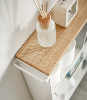 Aerial view of white Rolling Storage Cart holding clock and toilet paper by Yamazaki Home. view 6
