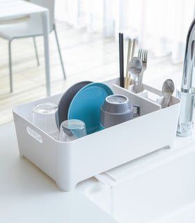 White Dish Rack holding dinnerware on kitchen counter by Yamazaki Home. view 2