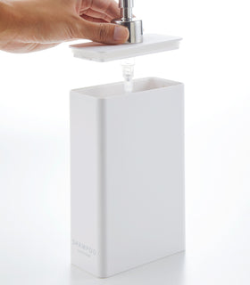 Side view of white Shampoo Dispenser with top off on white background by Yamazaki Home. view 3