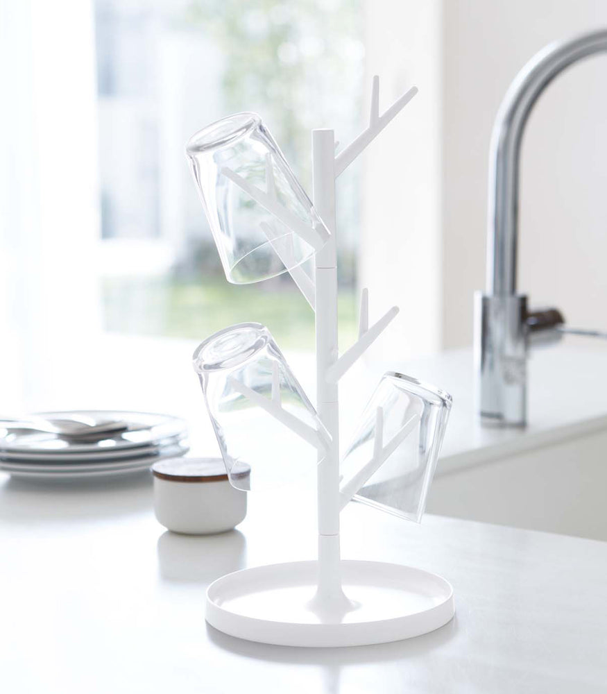 View 4 - Front view of white Glass & Mug Tree holding glasses by Yamazaki Home.