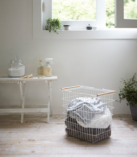Wire Laundry Basket holding clothes by Yamazaki Home. view 8