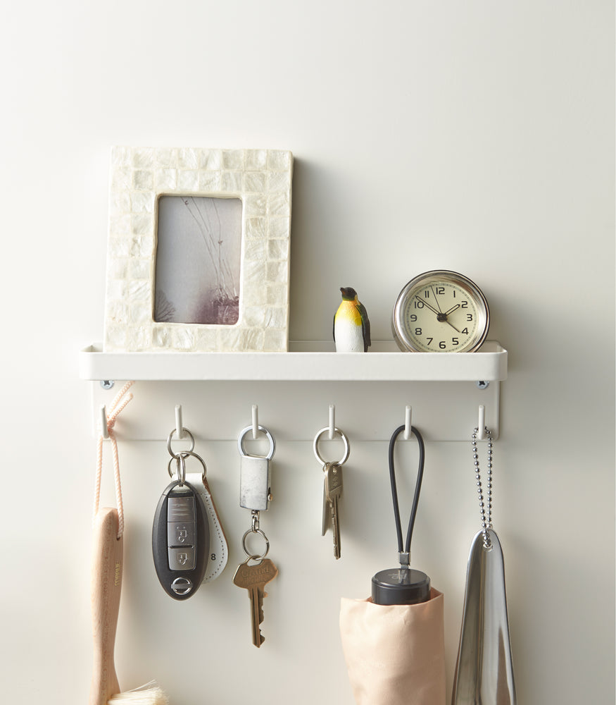 View 4 - Front view of white Magnetic Key Rack with Tray holding items and keys by Yamazaki Home.