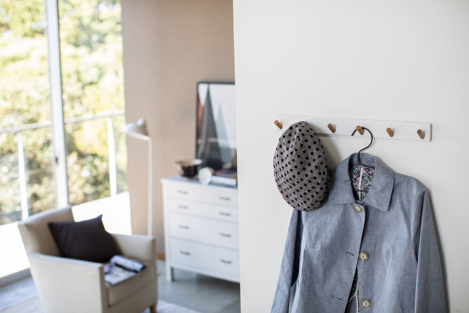View 3 - White Wall-Mounted Coat Hanger holding hat and jacket by Yamazaki Home.