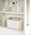 Front view of white Countertop Waste Bin on bathroom shelf by Yamazaki Home.