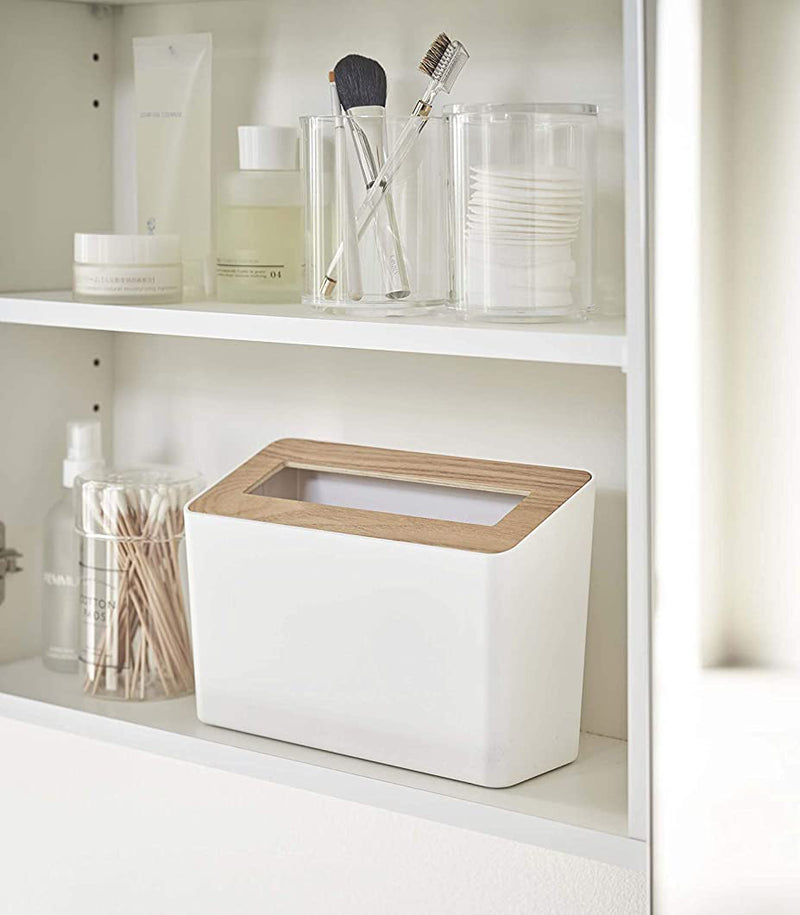 Front view of white Countertop Waste Bin on bathroom shelf by Yamazaki Home.