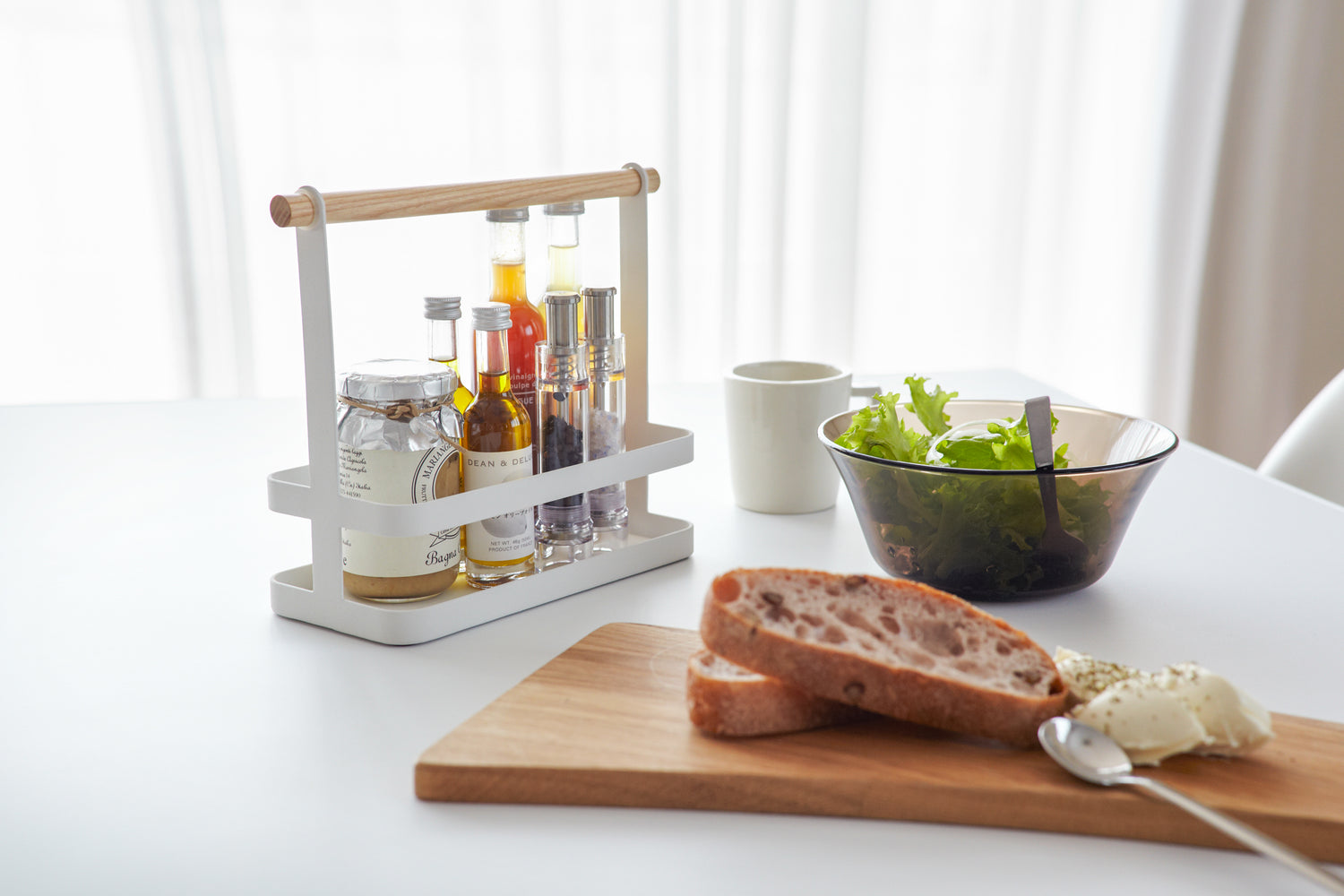 View 4 - White Countertop Storage Caddy holding spices and oil on dining table by Yamazaki Home.