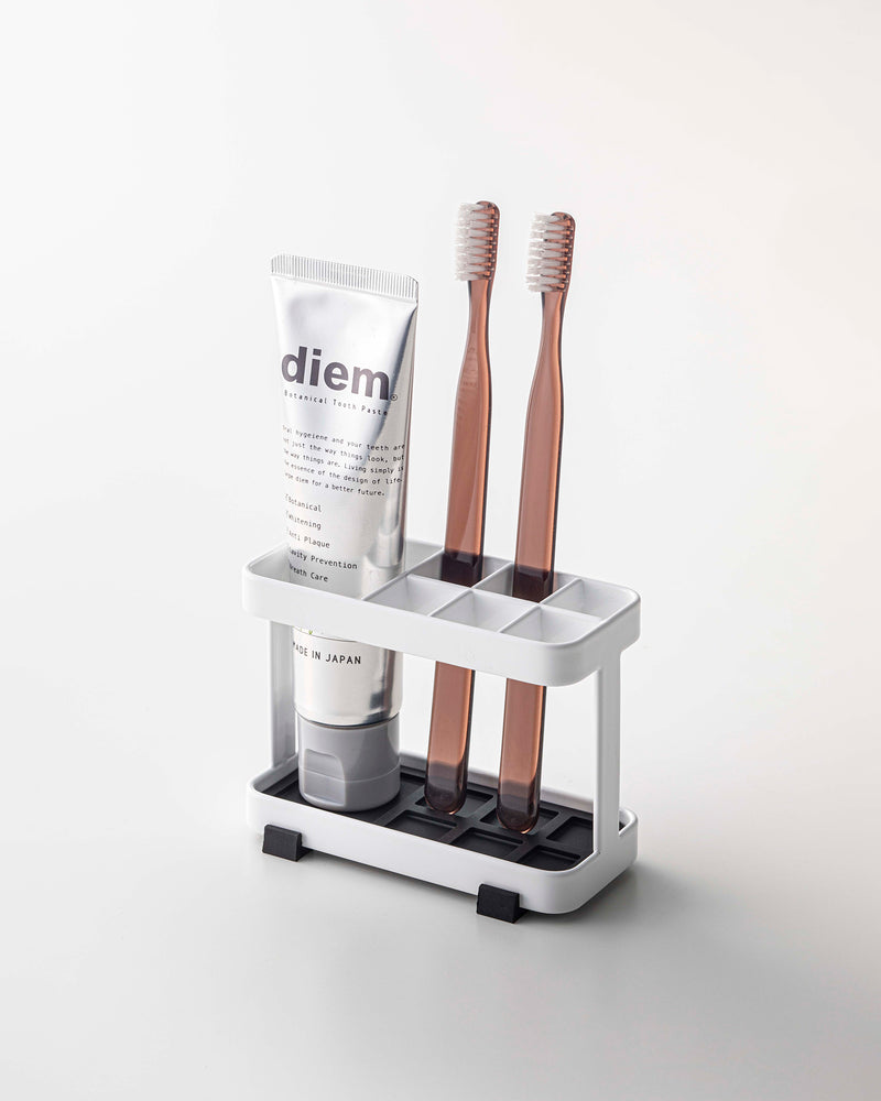 Prop photo showing Toothbrush + Toothpaste Stand with various props.