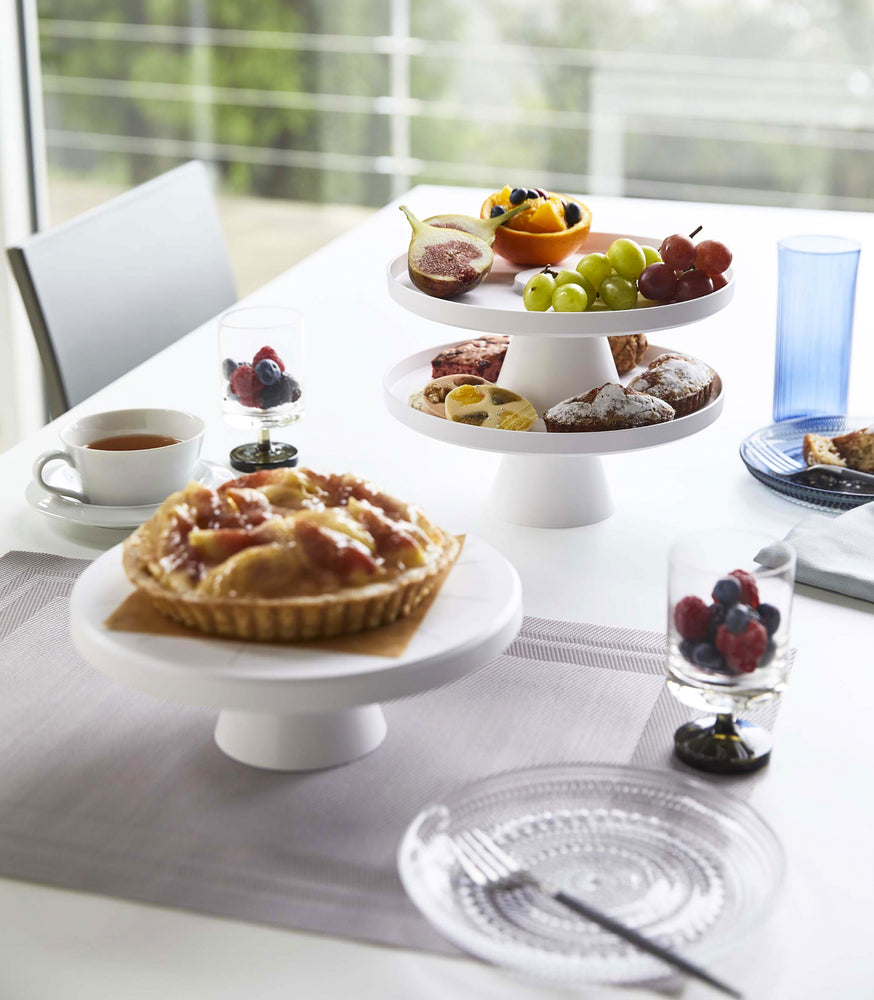 View 4 - White Stackable Serving Stand displaying fruit and pastries on dining table by Yamazaki Home.