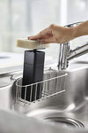 Black One-Handed Push Soap Dispenser in kitchen sink by Yamazaki Home.