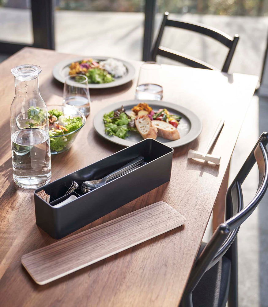 View 10 - Black Utensil Case holding utensils on dining table by Yamazaki Home.