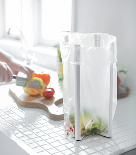 White Collaspsible Bottle Dryer holding compost bag by Yamazaki home. view 3