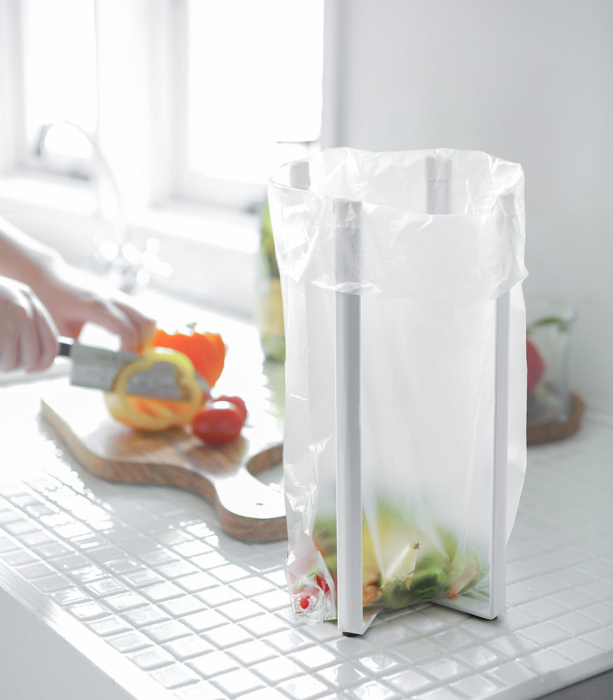 View 2 - White Collaspsible Bottle Dryer holding compost bag by Yamazaki home.