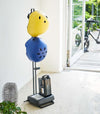 Black Kids' Helmet Stand holding helmets and bike gear by Yamazaki Home.