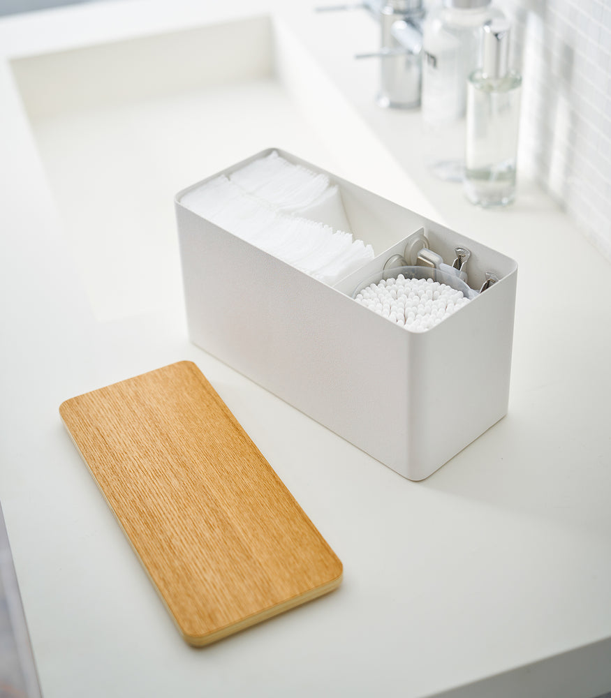 View 7 - White Countertop Organizer with lid off and holding beauty items on bathroom countertop by Yamazaki Home.