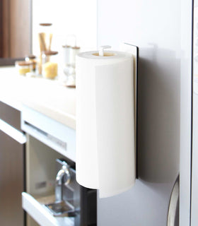 Magnetic Paper Towel Holder vertically holding paper towel in kitchen by Yamazaki Home. view 3