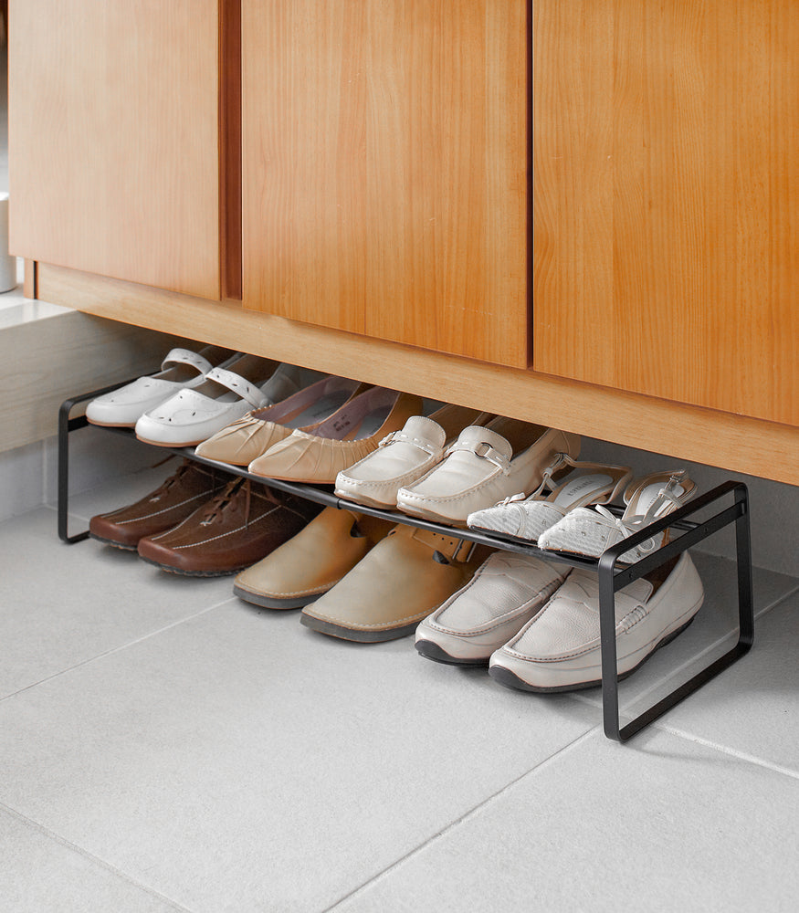 View 9 - Black entryway Stackable Shoe Rack holding shoes by Yamazaki Home.