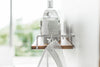 Close up side view of Wall-Mounted Shelf holding cleaning items by Yamazaki Home.