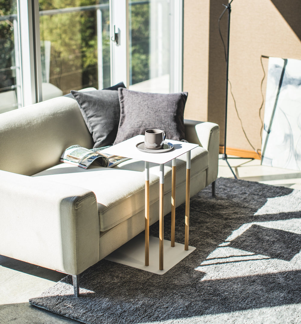 White C Side Table holding coffee cup in living room by Yamazaki Home.