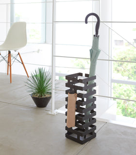 Front view of entryway black Shoe Rack holding shoes by Yamazaki home. view 8