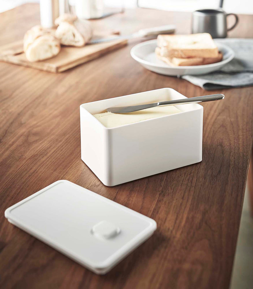 View 2 - White Vacuum-Sealing Butter Dish holding butter on table by Yamazaki Home.