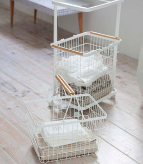 White Laundry Wagon and Basket holding clothes  by Yamazaki Home. view 6