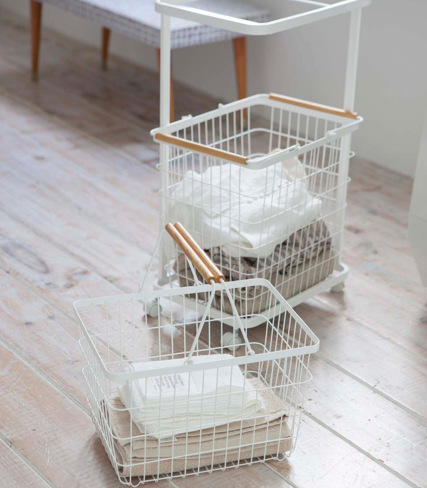 View 6 - White Laundry Wagon and Basket holding clothes  by Yamazaki Home.