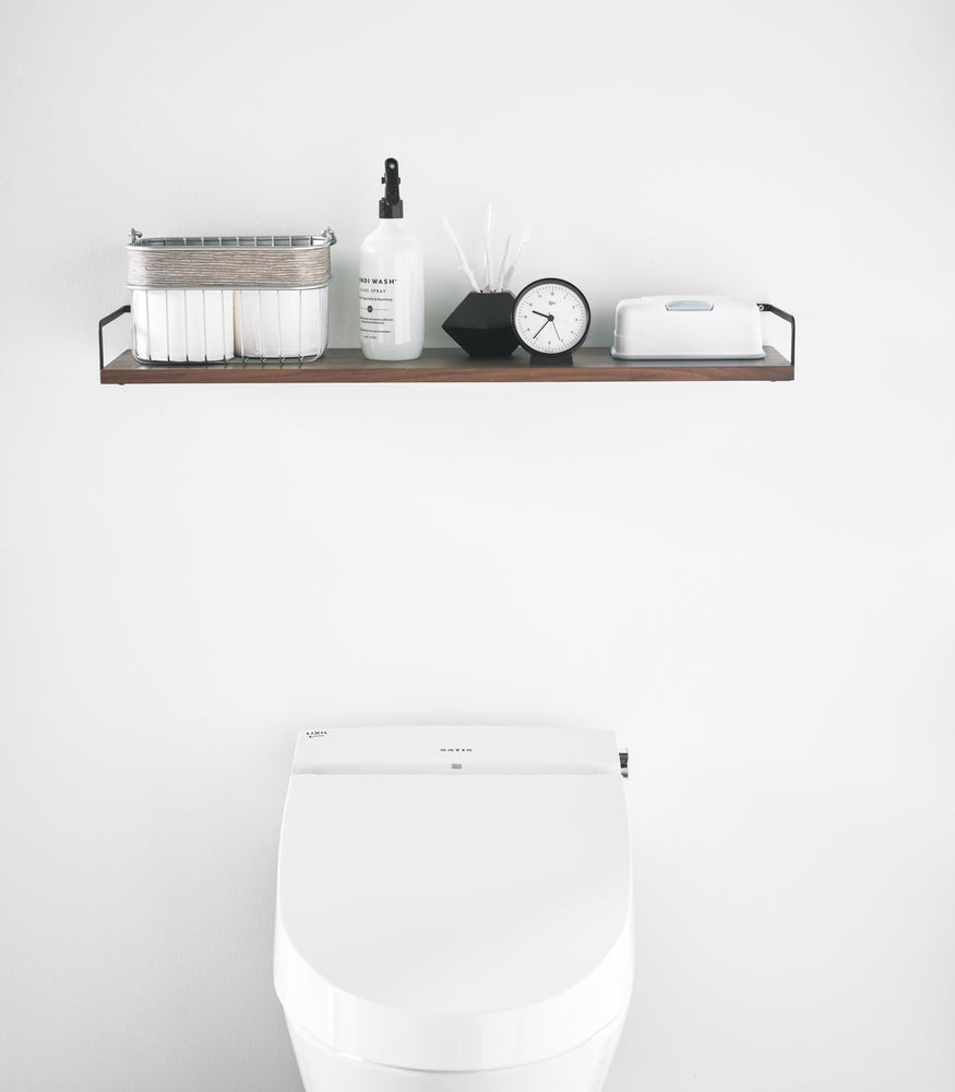 View 10 - Front view of Wall-Mounted Shelf holding bathroom items in bathroom by Yamazaki Home.