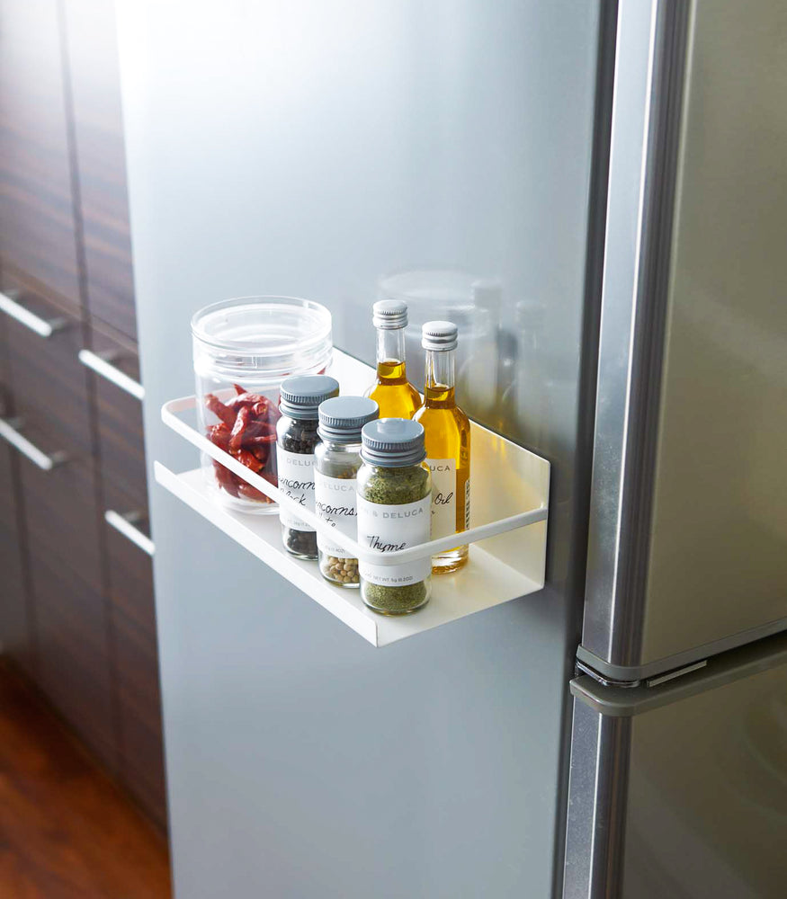 View 4 - White Magnetic Storage Caddy containing spices and oil on fridge by Yamazaki Home.