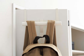 Close up front view of White Kids' Backpack Hanger holding a backpack on door by Yamazaki Home. view 6