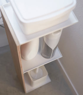Close up aerial view of Toilet Paper Stocker holding bathroom accessories in bathroom by Yamazaki Home. view 6