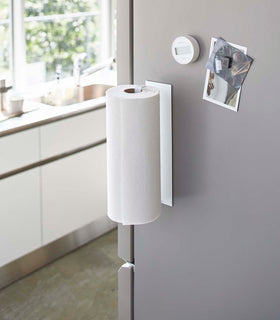 Vertical White Magnetic Paper Towel Holder holding paper towels in kitchen by Yamazaki Home. view 3