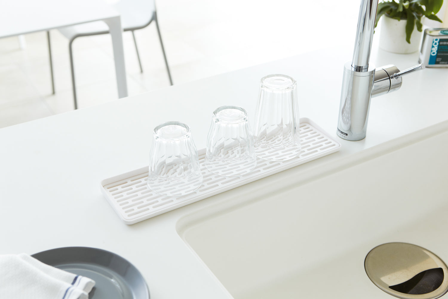 View 2 - White Sink Drainer Tray with glasses on sink counter by Yamazaki Home.