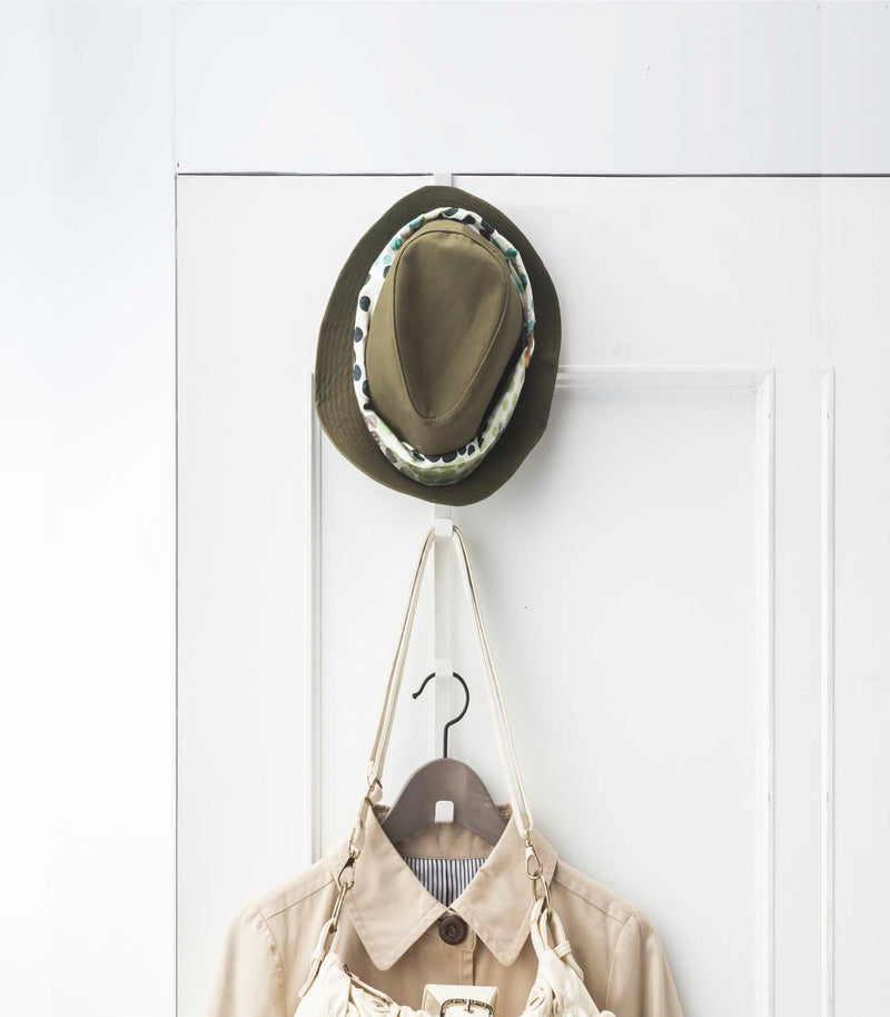 Front Door Over-the-Door Hanger displaying hat, purse, and jacket on door by Yamazaki Home.
