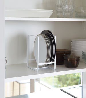 White Dish Storage Rack holding plates in kitchen by Yamazaki Home.