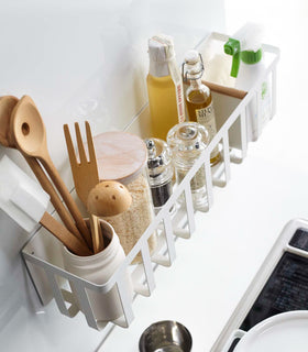 Aerial view of white Magnetic Storage Basket containing oils, spices, and utensils in kitchen by Yamazaki Home. view 4