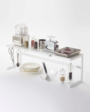 Prop photo showing Expandable Countertop Shelf with various props.