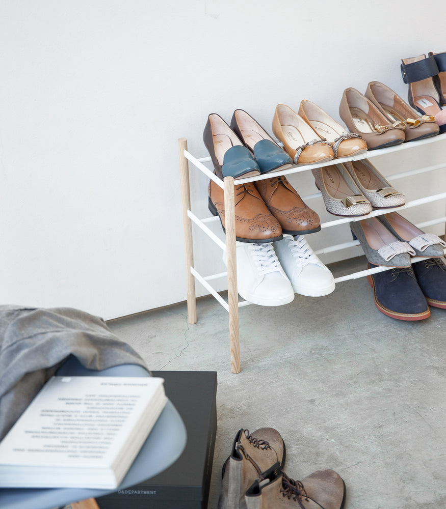 View 5 - Expandable shoe rack in white holiding shoes by Yamazaki Home.