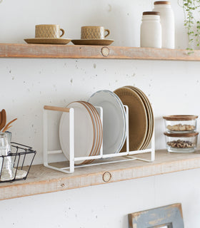 Wood-Accented Dish Storage Rack holding plates on kitchen shelf by Yamazaki Home. view 3