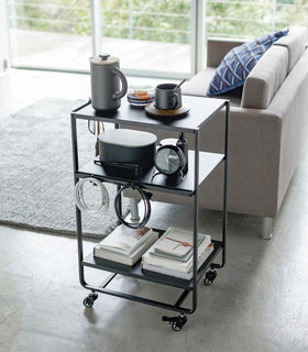 Black Rolling Utility Cart displaying items in living room by Yamazaki Home. view 10