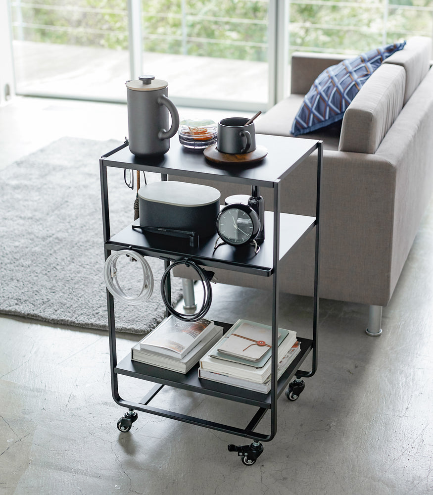 View 10 - Black Rolling Utility Cart displaying items in living room by Yamazaki Home.