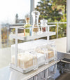 White Undershelf Organizer holding cooking ingredients by Yamazaki Home.