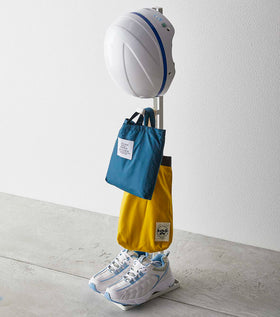 White Kids' Helmet Stand holding bags, helmet, and sneakers by Yamazaki Home. view 2