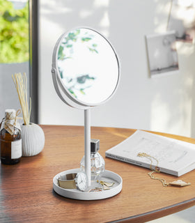 White Vanity Mirror holding earrings, watch and perfume bottle on table by Yamazaki Home. view 2