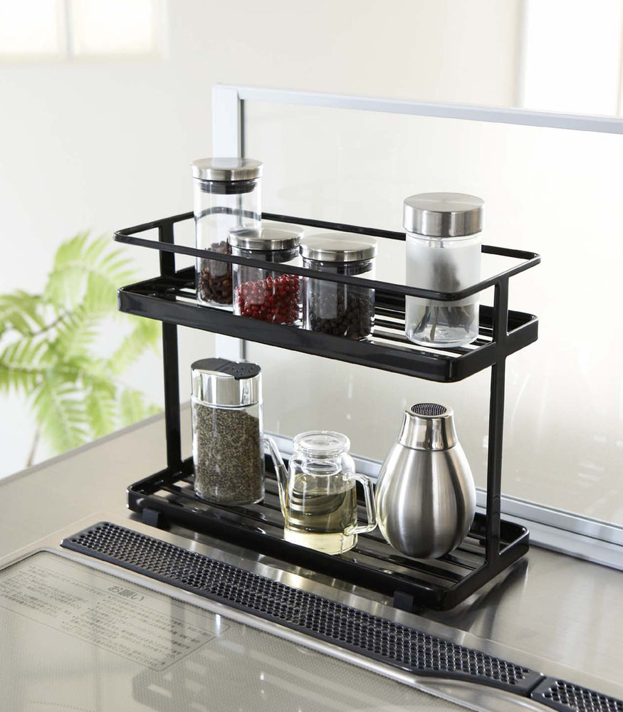 View 4 - Black Organization Caddy on kitchen stovetop holding spices and oil by Yamazaki Home.