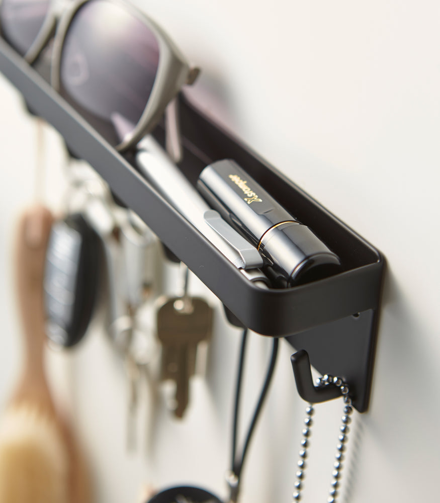 View 11 - Close up view of black Magnetic Key Rack with Tray holding keys and sunglasses by Yamazaki Home.