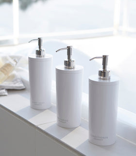 Yamazaki Home white Shampoo, Conditioner, and Body Soap dispensers in bathroom. view 7
