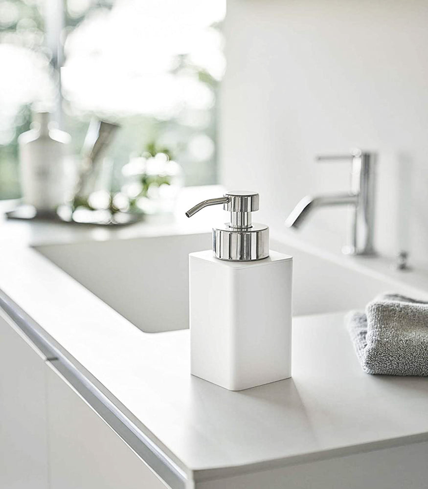 View 2 - White Foaming Soap Dispenser on bathroom sink countertop by Yamazaki Home.