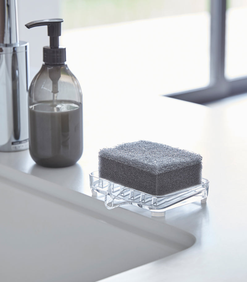 Self Draining Soap Tray on holding sponge on sink counter by Yamazaki Home.